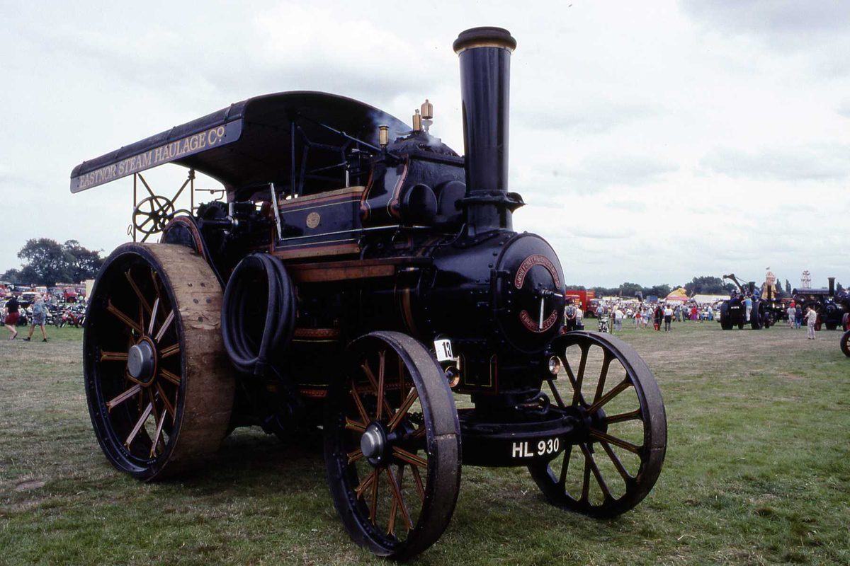 Preserved 1911 Fowler B6 road locomotive 'Titan' in dark livery with a canopy reading Eastnor Steam Haulage Co, standing on a rally field